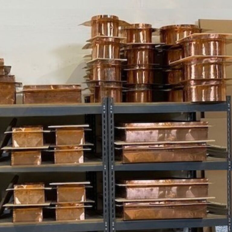 Stock of various sizes of copper RF waveguide ventilation honeycomb ready for installation.