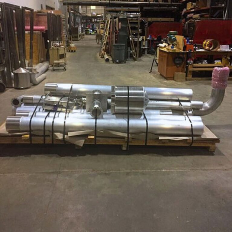 Custom fabricated non ferrous cryogen vent duct system lying on shop floor before MRI site installation.