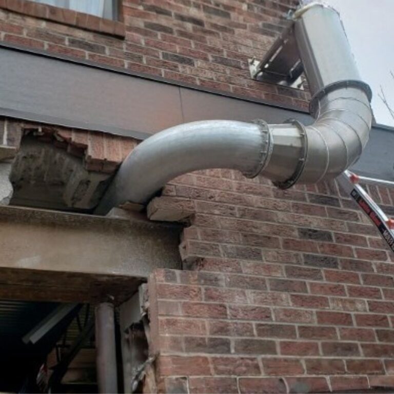 Non ferrous cryogen vent ductwork installed through a brick exterior wall during MRI suite construction.