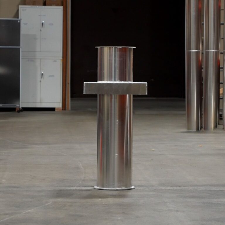 Fabricated mid section of stainless steel cryogen vent pipe resting on warehouse floor.