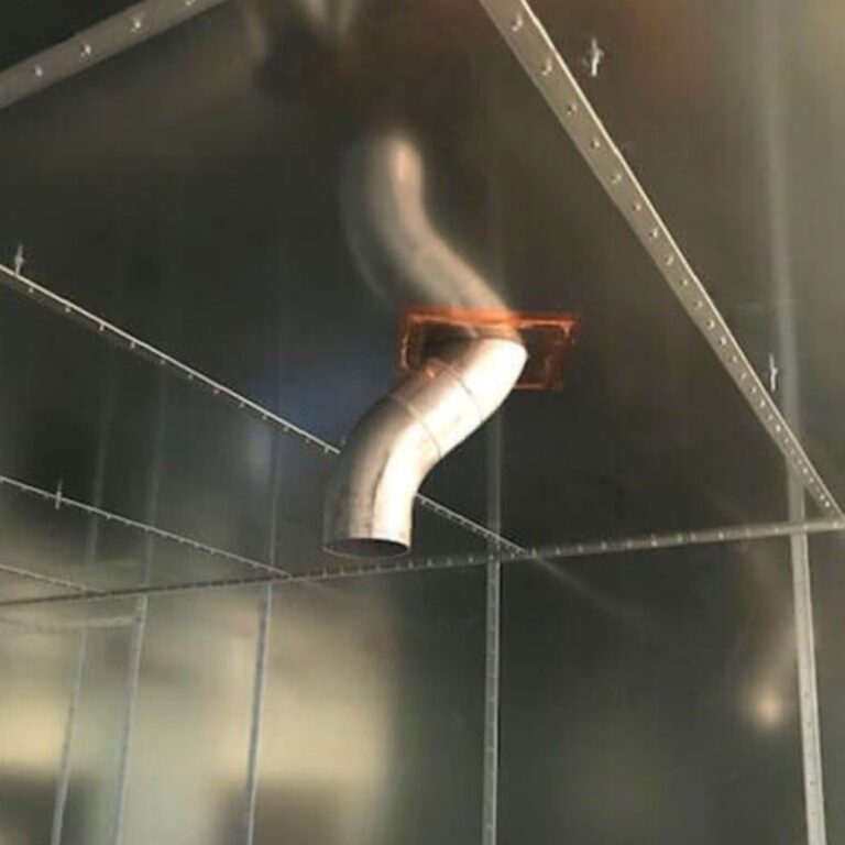 Interior view of a curved cryogen pipe passing through the finished RF shielded enclosure.