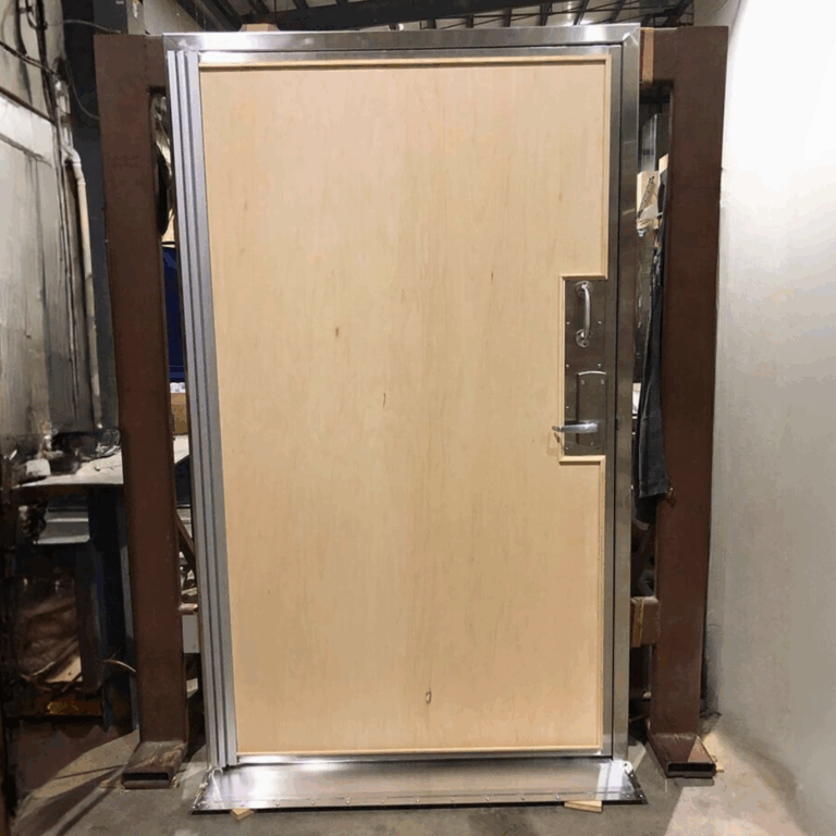 Light wood grain RF shielded door undergoing final quality checks and assembly at the factory.