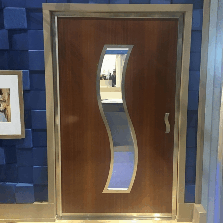 Dark wood RF shielded door with custom wavy viewing window and modern blue wall background.