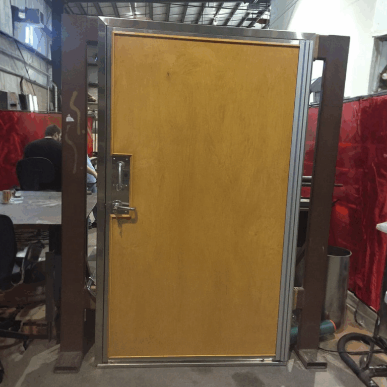 Factory view of a finished wood veneer RF shielded door ready for installation in an MRI suite.