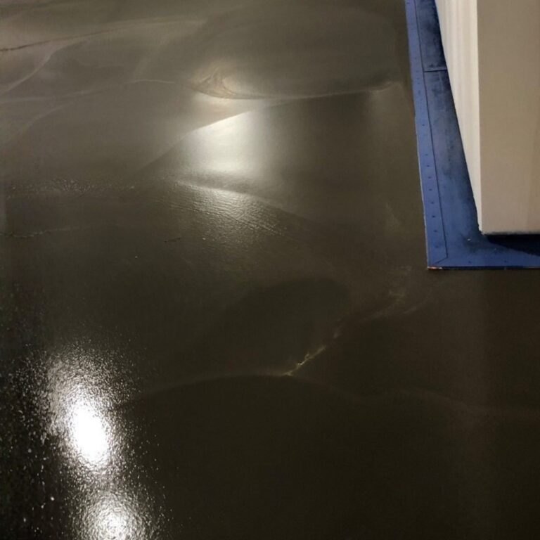 Dark, self leveling epoxy coating applied over the RF shielding floor for seamless MRI room surface.