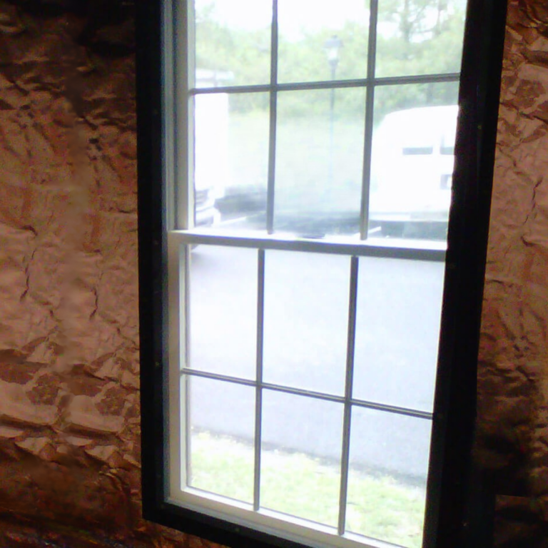 Gridded pane RF shielded window providing exterior visibility within a copper lined MRI suite.