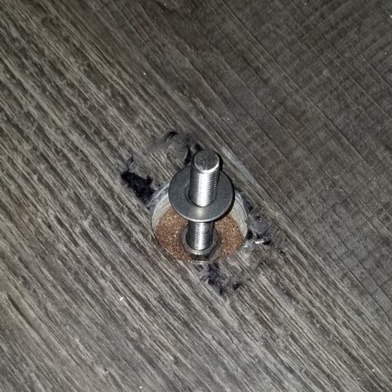 Close up of a foundation grounding bolt secured in the floor for MRI equipment installation.