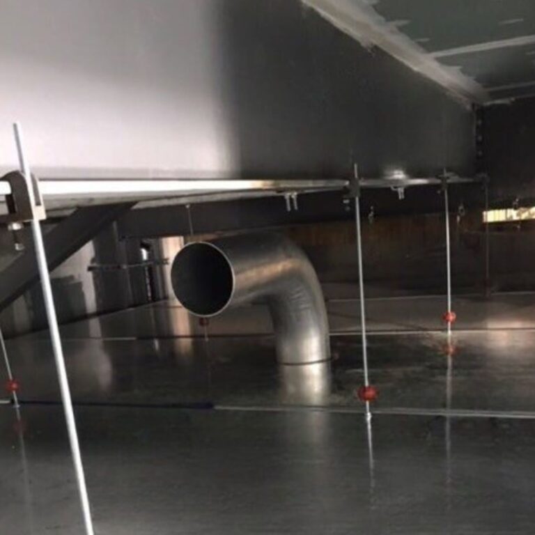 Large non ferrous pipe waveguide penetration installed in the floor shield during construction.