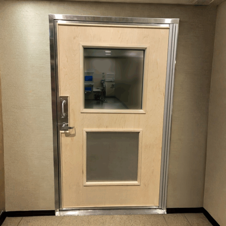 Light wood RF shielded MRI door featuring a large viewing window and a metal frame.