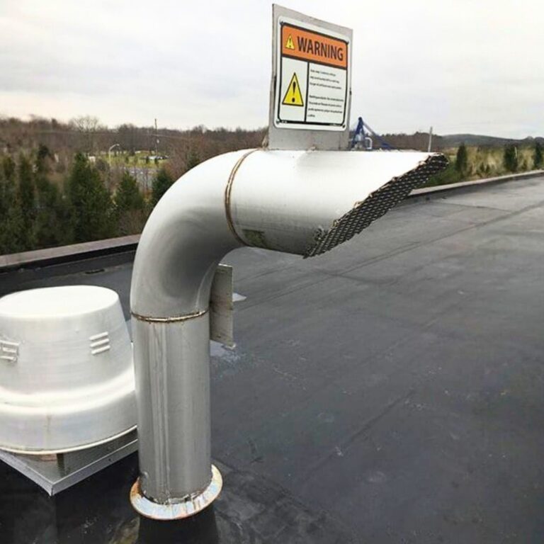 Long horizontal run of non ferrous cryogen quench pipe supported by stands on rooftop.