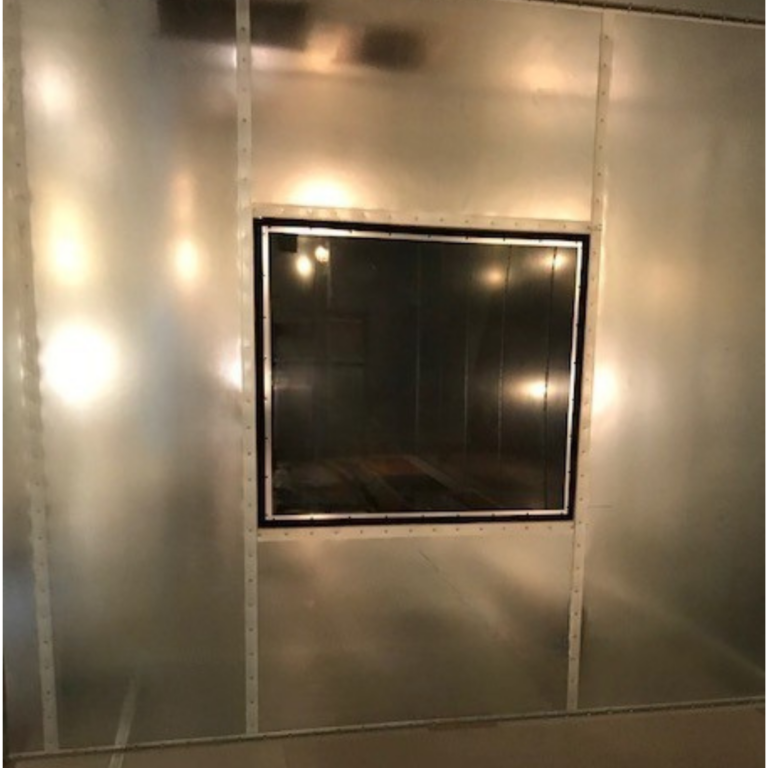 Square RF shielded window installed in a modular galvanized steel MRI shielding wall.