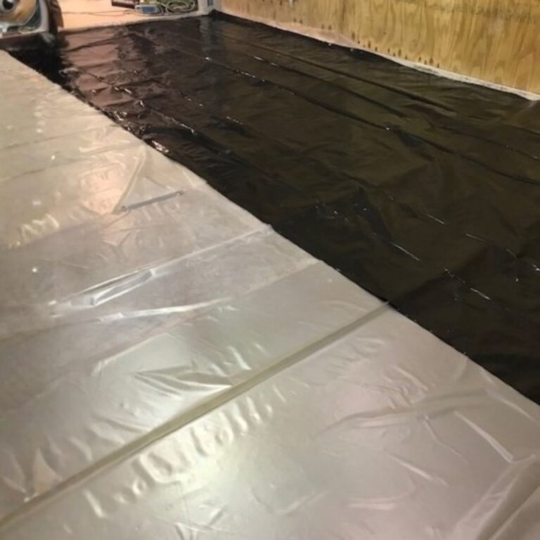 Plastic vapor barrier laid out on the floor before installation of RF shielding panels.