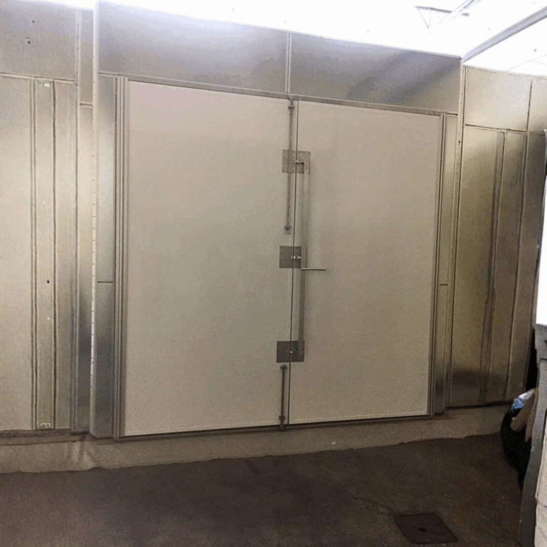 Extra wide double leaf RF shielded door with heavy duty securing mechanisms for large equipment access.