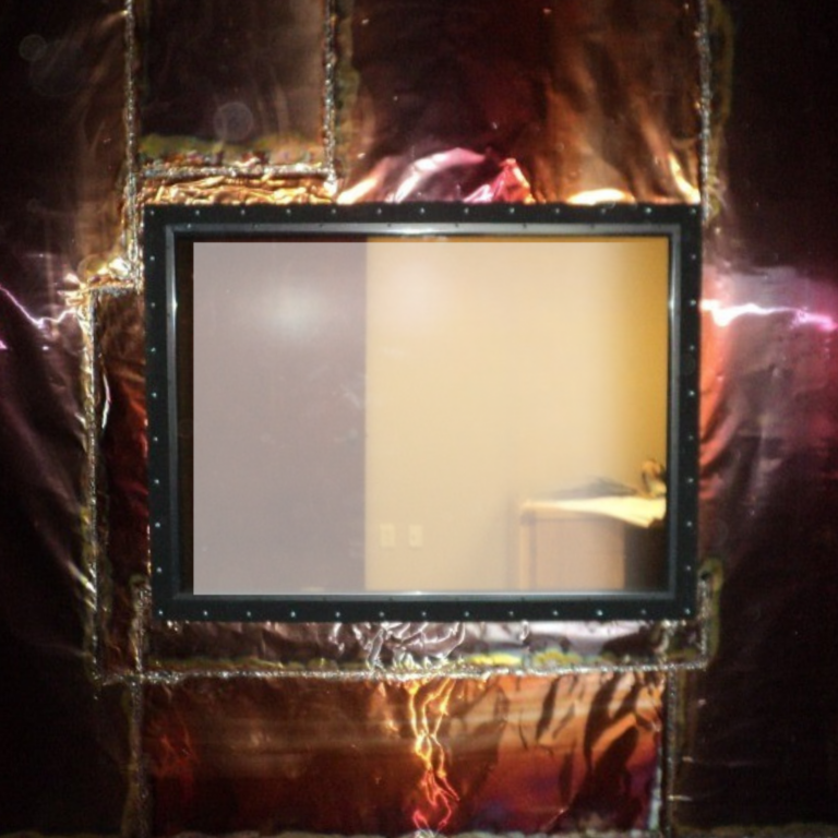 Wide rectangular shielded window installed in copper RF shielded modular wall.