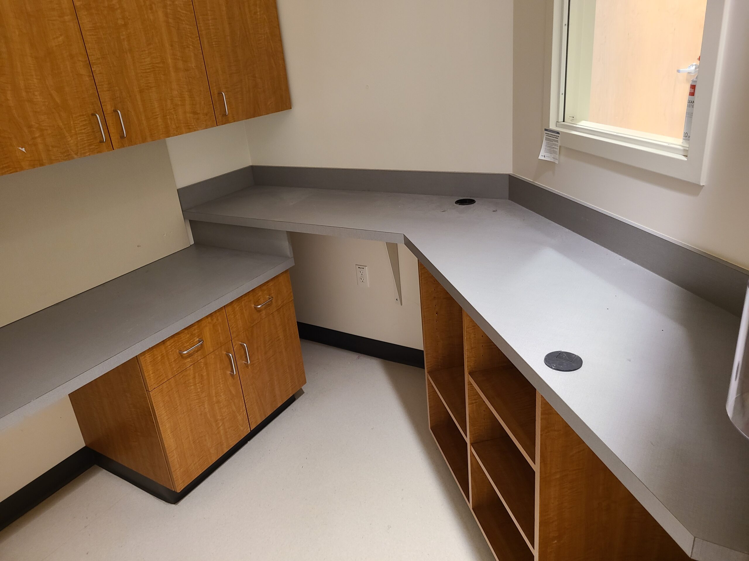 A decommissioned lead-lined control booth window and desk after technical deinstallation.