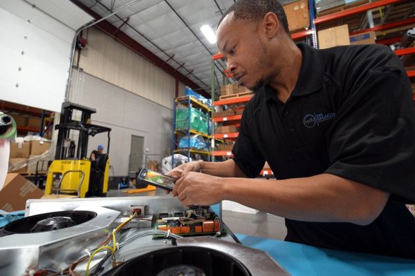 MXR Imaging Technician Inspecting Diagnostic Imaging Electronics