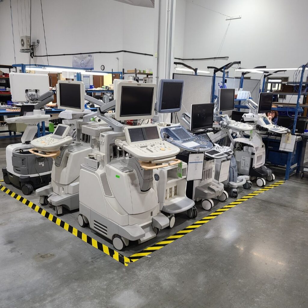 A row of refurbished ultrasound machines ready for distribution at an MXR Imaging facility.