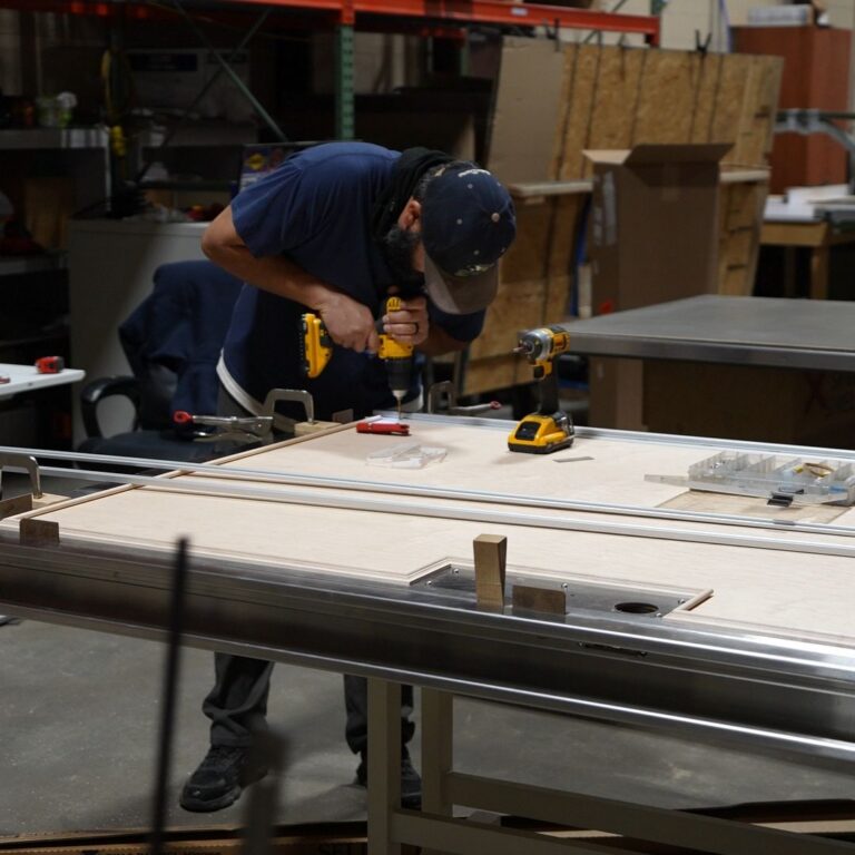 An MXR technician assembling specialized door for an RF shielded medical imaging room.