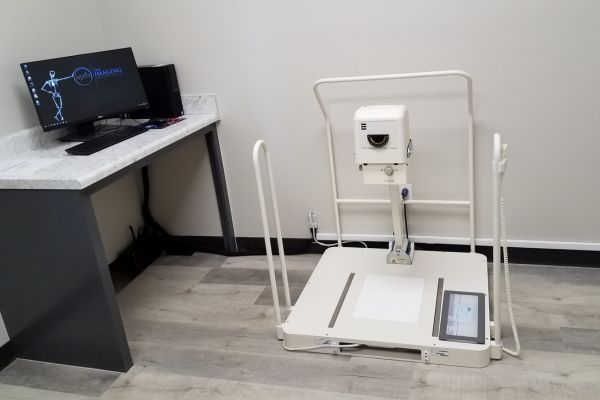 Weight bearing podiatry X ray system for foot and ankle imaging in medical clinic.